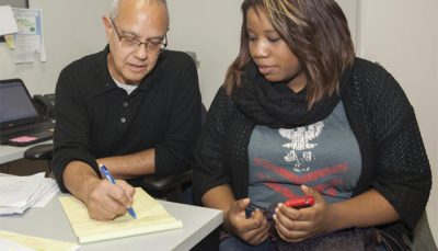 Photo Of A Man And Woman Taking Notes